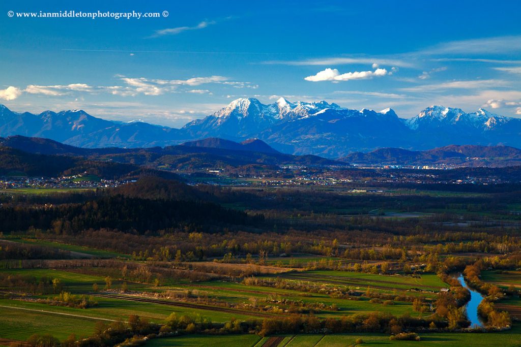 View of the Kamnik Alps mountain range and the Ljubljanica river running though the Ljubljana Marshes, seen from the hilltop church of Saint Ana.