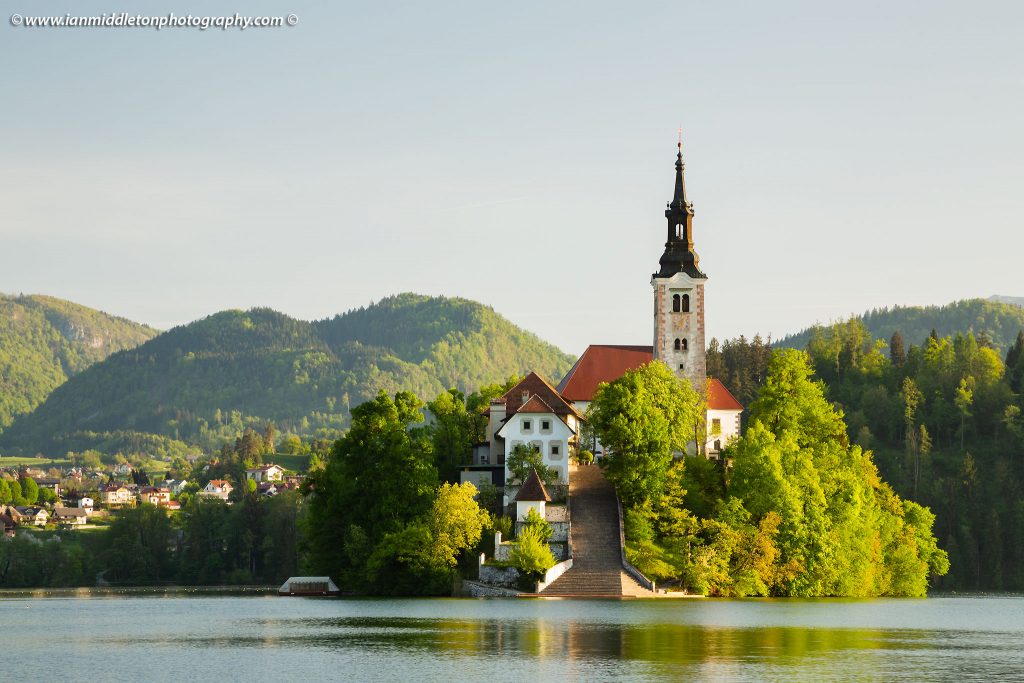 Spring morning view across Lake Bled to the island church of the assumption of saint mary, Slovenia.